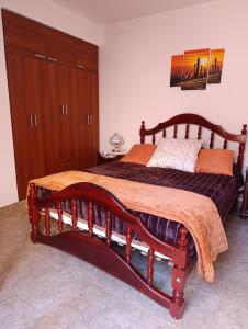 a bedroom with a large wooden bed in a room at Hospedaje Las Rosas in La Quiaca