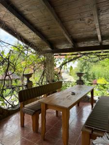 ein Holztisch und Bänke auf einer Terrasse in der Unterkunft Сідус in Schidnyzja