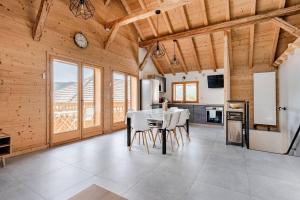 a kitchen and dining room with a table and chairs at L'échappée Belle en Montagne - site location-chalet in Mieussy