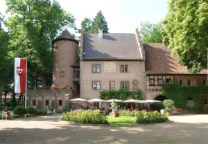 a large building with a building with a tower at Evelyns Apartment Kurpark Idylle in Bad Bocklet