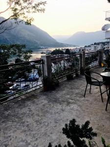 a balcony with a table and chairs and a view at Apartments Parapid in Kotor
