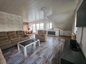 a living room with a couch and a table at Ferienglück Sundern in Sundern