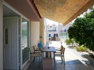 a wooden table and chairs on a patio at Patrikon House in Kardamaina