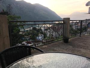 a table on a balcony with a view of the water at Apartments Parapid in Kotor
