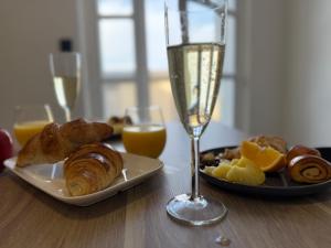 a table with a plate of food and a glass of champagne at l hibou in Avranches