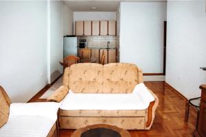 a living room with a couch and a kitchen at Central in Nikšić +9 photos