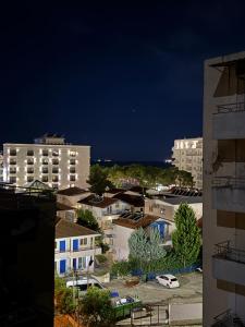 a view of a city at night with buildings at DG Apartment in Golem