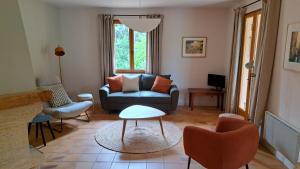 a living room with a blue couch and chairs at Maison Aksel in Beaumes-de-Venise +10 photos