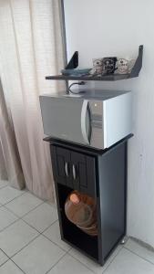 a microwave sitting on top of a stand in a room at Maravilla en el Centro Histórico de GDL in Guadalajara