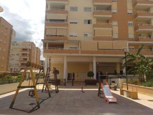 a playground in front of a large building at Paraiso alquiler vacacional in Málaga