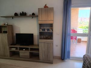 a living room with a tv and a book shelf at Paraiso alquiler vacacional in Málaga