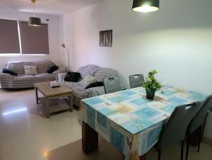 a living room with a table and a couch at Paraiso alquiler vacacional in Málaga