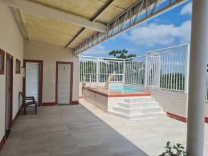 a porch of a house with a swimming pool at Apto na COP 30 in Belém