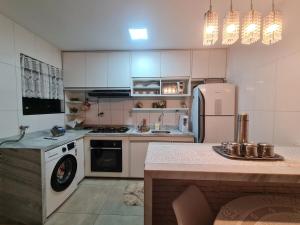 a kitchen with a white refrigerator and a stove at Apto na COP 30 in Belém +21 photos