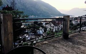 a fence with a view of a body of water at Apartments Parapid in Kotor