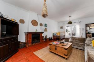 a living room with a couch and a fireplace at Villa Sesta in Vila de Frades +36 photos