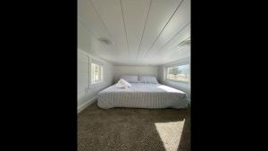 a white bedroom with a bed and a window at Rate Drop! Enjoy the Simplicity-Teton Tiny House L in Tetonia