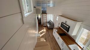 a tiny house with a staircase and a tv at Rate Drop! Enjoy the Simplicity-Teton Tiny House L in Tetonia
