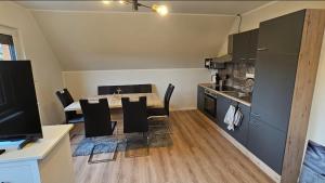 a kitchen and dining room with a table and chairs at Meehr-Laboe in Laboe