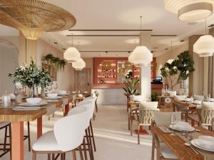 a restaurant with wooden tables and white chairs at Adiya Signature Hotel - Adults only in Kotor