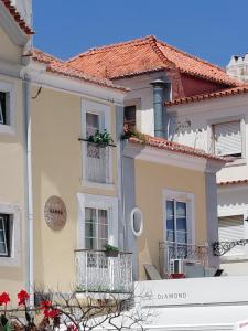 una casa con balconi e tetto rosso di Suites Bambu a Setúbal