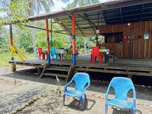 a playground with colorful chairs and tables in a building at Cabaña y restaurante vikana in Nuquí