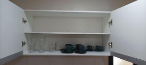 a cupboard with a bunch of dishes and glasses at Apartamento Luxuoso decorado e mobiliado in Ribeirão Preto