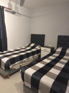 En eller flere senge i et værelse på Departamento ANDES