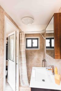 a bathroom with a sink and a mirror at Matira TINY HOUSE 1 in Bora Bora +20 photos