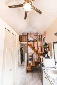 a tiny house with a spiral staircase in a kitchen at Matira TINY HOUSE 1 in Bora Bora