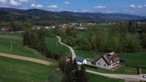 a house in the middle of a field with a road at Willa Gorce in Ostrowsko