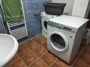 a washing machine and a washer in a bathroom at Farma na Lazoch in Slatinské Lazy