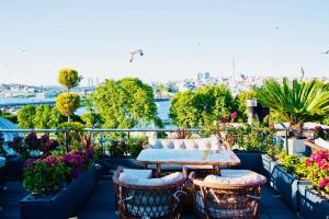 a table and chairs on a balcony with flowers at Patio SeaShore in Istanbul