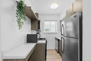 a kitchen with a stainless steel refrigerator at Harding Apartments by Andes STR in Miami Beach
