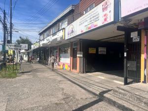 a person walking down a street in front of a building at DEPARTAMENTOS CLIMENT in Osorno