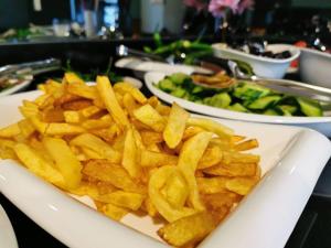 a plate of french fries on a table with other plates of food at Patio SeaShore in Istanbul +25 photos