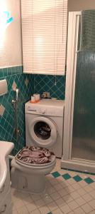 a bathroom with a toilet with a towel on the seat at Residenza Verde Mare Cugnana village in Cugnana Verde