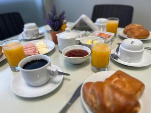 a table with breakfast foods and a cup of coffee at Vianca Hotel in Machu Picchu