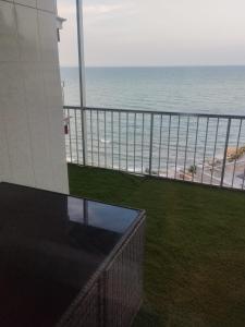 a view of the beach from the balcony of a building at APARTAMENTO Claudia FARO in Faro de Cullera