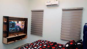 a living room with a tv and a couch at Daprem Luxury Self Contained Apartments in Uyo