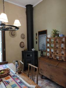 a dining room with a table and a dresser at Santa Angela alojamiento de campo in Salto