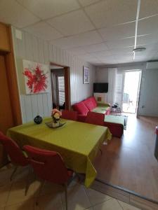 a living room with a table and a couch at Apartments with parking space Lopar, Rab - 5019 in Lopar