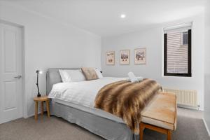 a bedroom with a bed with a fur blanket on it at Candoux 2 AMS Mt Buller in Mount Buller