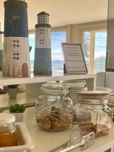 a shelf with two lighthouses on top of a counter at Costanera Hotel in Puerto Madryn +68 photos