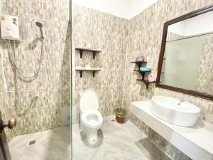 a bathroom with a toilet and a sink and a shower at Luang Prabang Pavilion Hotel & Travel in Luang Prabang +104 photos