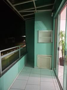 a room with a green wall and a door at Edifício Vitória 1 Apt 501 in Marcelino Ramos