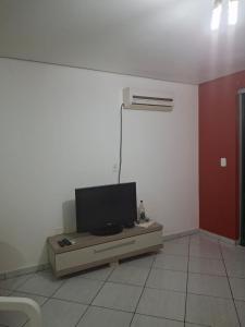 a living room with a flat screen tv on a table at Edifício Vitória 1 Apt 501 in Marcelino Ramos