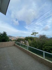 a balcony with a view of a city at Suites mirante da Enseada in Guarujá
