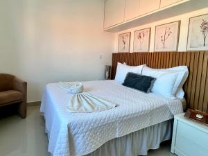 una camera da letto con un letto e un asciugamano sopra di Casa Trindade - Residencial Caminho da Praia a Porto Seguro