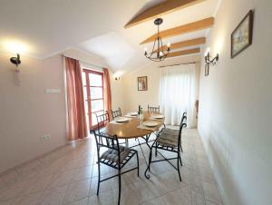 a dining room with a wooden table and chairs at Holiday home Balatonalmadi - Balaton 17957 in Balatonalmádi